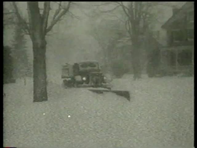 Cars are buried in snow, truck and tractor clear roads, man clears yard in towns during and after snowfall in the USA circa 1958 - MGM PICTURES, UNIVERSAL-INTERNATIONAL NEWSREEL, USA, filmed in 1958 