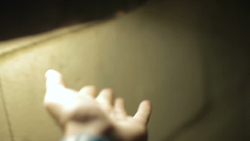 Man hand walks past a cave lamps
