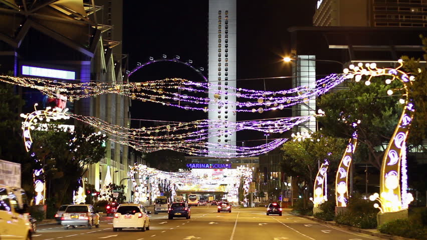 SINGAPORE - NOVEMBER 29: Cars and regular buses pass below the Christmas light-up of a broad avenue on November 29, 2009 in Singapore. Singapore is well-known for its extensive Christmas decor.