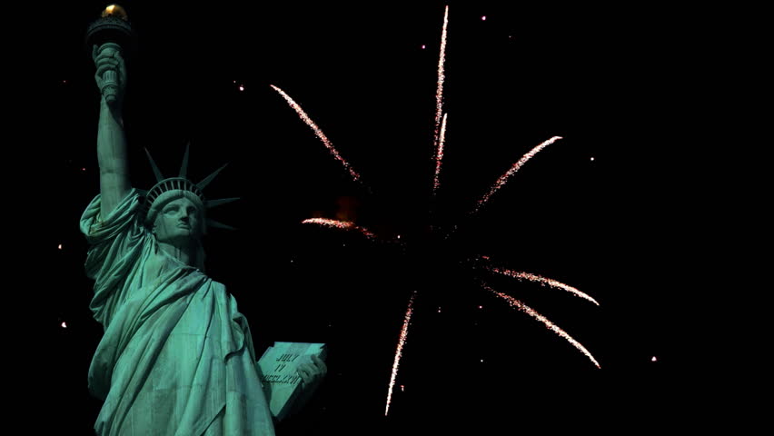 Statue of Liberty with fireworks in the background.