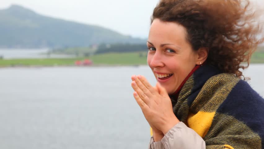 Beautiful woman wrap up in plaid onboard liner in afternoon