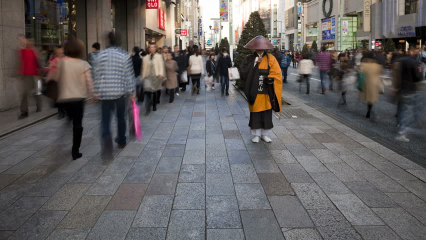 TOKYO, JAPAN - CIRCA MAY 2011: Shinto priest seeking donations (Alms) on the main shopping street in Ginza