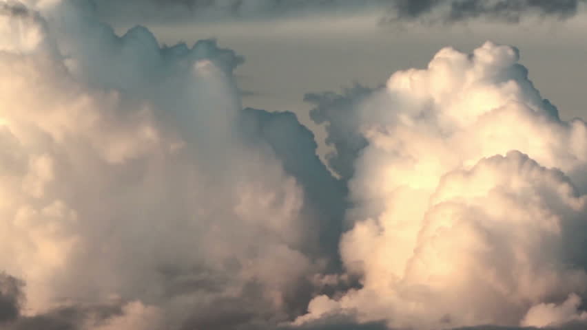 Formation of large cumulonimbus clouds at sunset. Close-up until sundown.