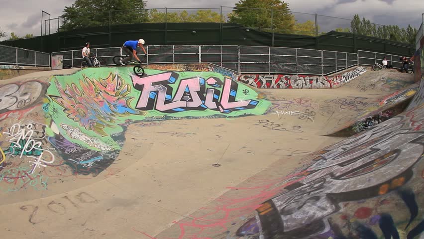 BMX bike rider takes a hard crash in a skateboard park