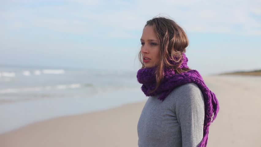 Beautiful girl deep in thought on beach

