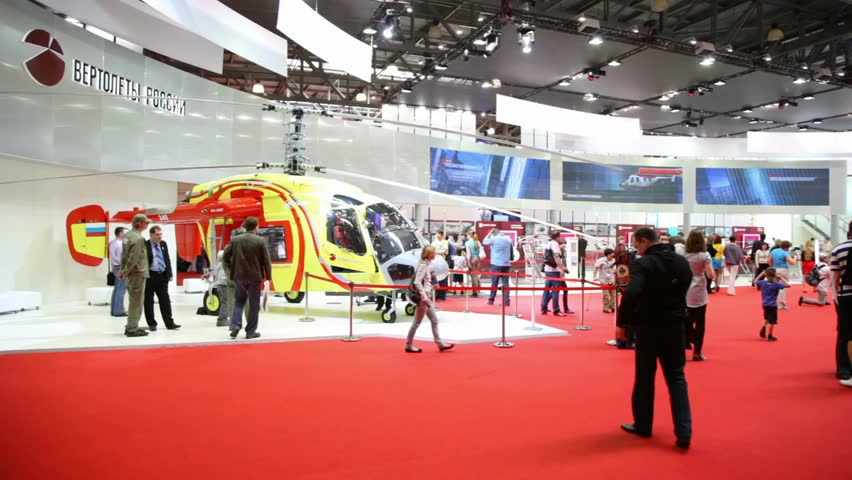 MOSCOW - MAY 21: Visitors walk on International exhibition of helicopter industry of Helirussia in Exhibition center Expo Crocus, on May 21, 2012 in Moscow, Russia