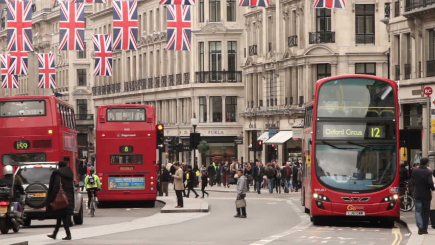 LONDON - MAY 14: Buses drive along Regent Street on May 14, 2012 in London. Regent Street is bedecked with British flags to celebrate the Olympic Games.