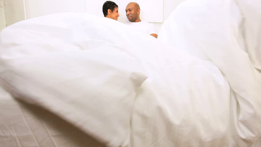 African American family sharing time bedroom home weekend