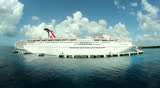 COZUMEL, MEXICO - July, 2012 The cruise ship Carnival Paradise as seen from the Carnival Elation as it leaves port at Cozumel, Mexico. MAY BE SUITABLE FOR EDITORIAL USE ONLY.