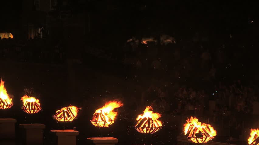 PROVIDENCE, RHODE ISLAND - CIRCA JULY 2010: Waterfire Art Event -- burning caldrons of wood with gondola passing by
