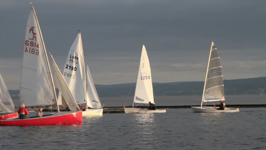 WIRRAL, CHESHIRE/ENGLAND - MAY 16: Unidentified sailboats and crew sail on the Marine Lake on May 16, 2012 in West Kirby. The Marine Lake is a man made coastal lake fed by the sea at high tide.