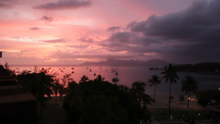 Sunset behind Moorea Island Mountains seen from Tahiti, in French Polynesia. (Realtime)