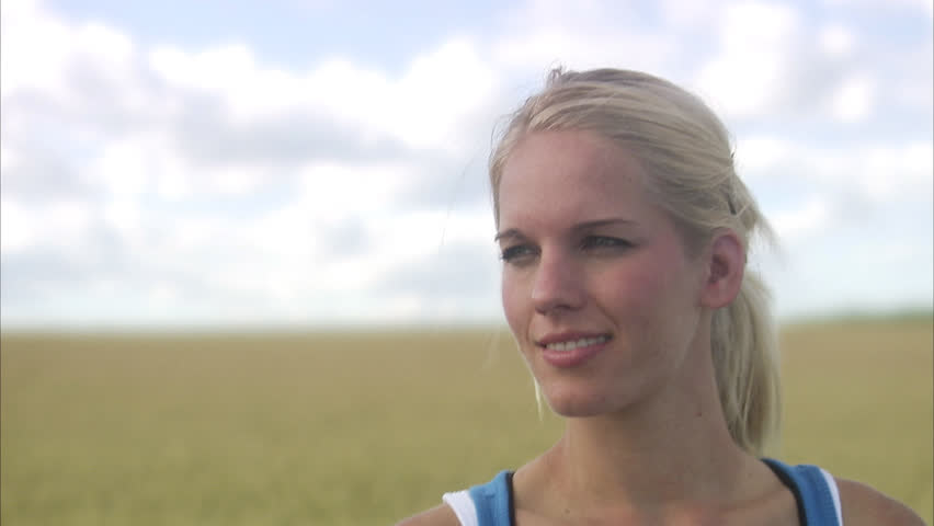 A woman next to a corn field