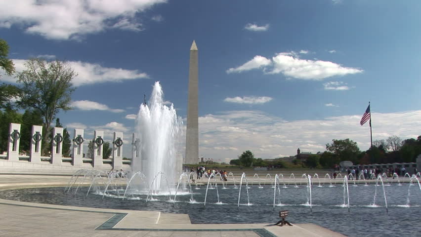 Visitors to the World War II Memorial mill around the large pool with spouting fountains.
