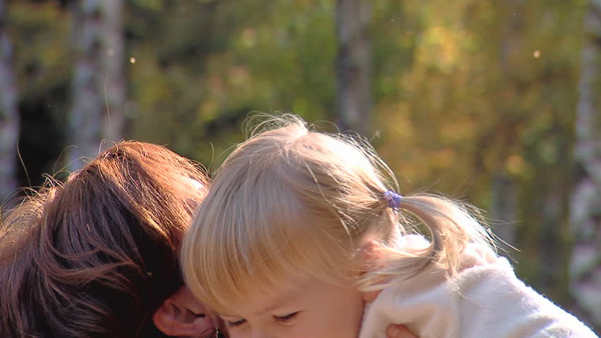 The happy little girl on hands of mum