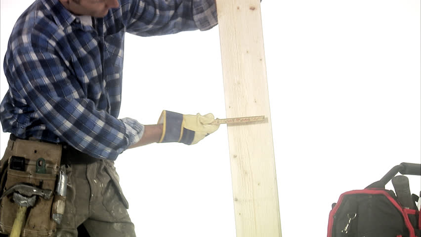 A craftsman using a folding rule.