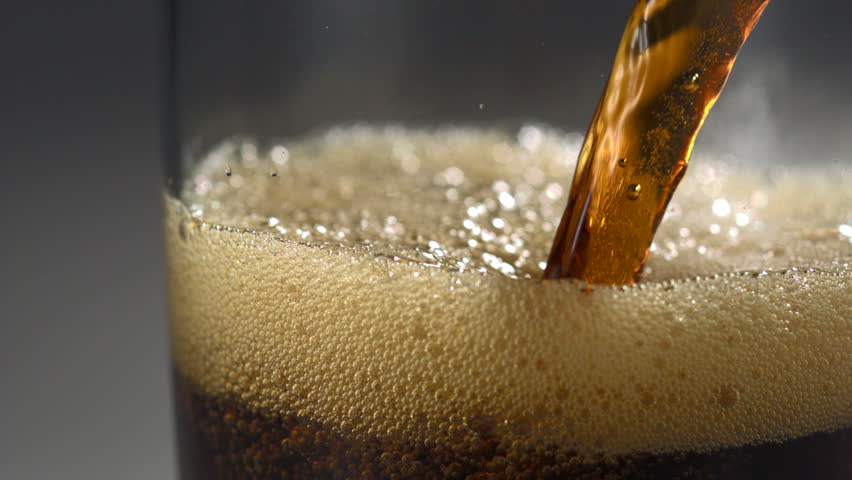 Pouring cola into glass shooting with high speed camera.