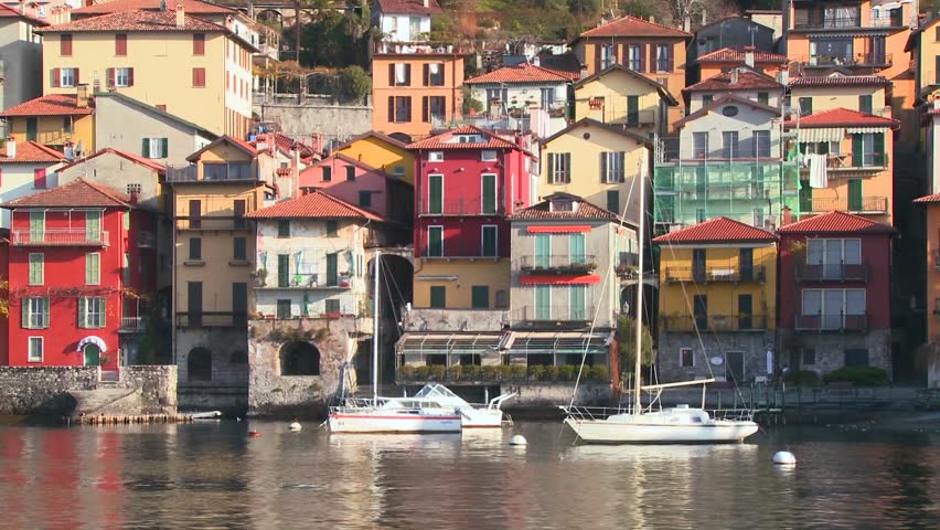 LAKE COMO, ITALY-CIRCA 2011-POV from a boat of the shores of Lake Como with the town of Varenna and the Italian Alps in background.