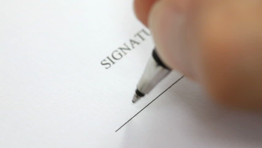 Hand signing a contract in black ink. Signature is fake. Detail