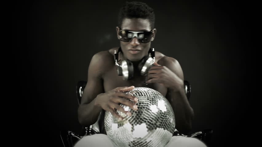 young cool african guy waving and dancing with glasses and disco ball