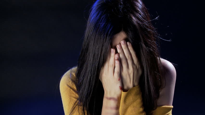 Beautiful woman crying showing blood in face because of domestic violence