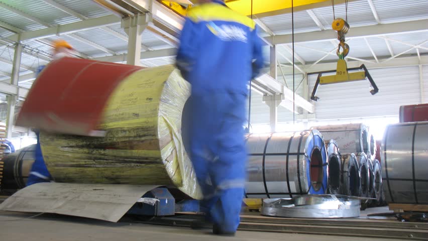 LOBNYA - JUN 7: (Timelapse View) Workers remove packing from roll of metal, at plant of roofing and wall materials Metall Profile, on Jun 7, 2012 in Lobnya, Russia