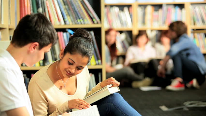 College class of multi ethnic young students learning in modern information library
