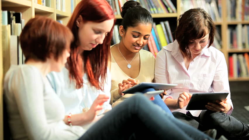Multi ethnic female classmates study online education in campus hub