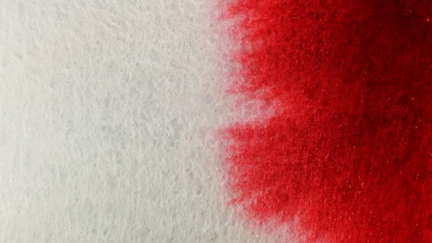 Dripping  Ink on Paper. The paper absorbs Ink paint. Macro.
