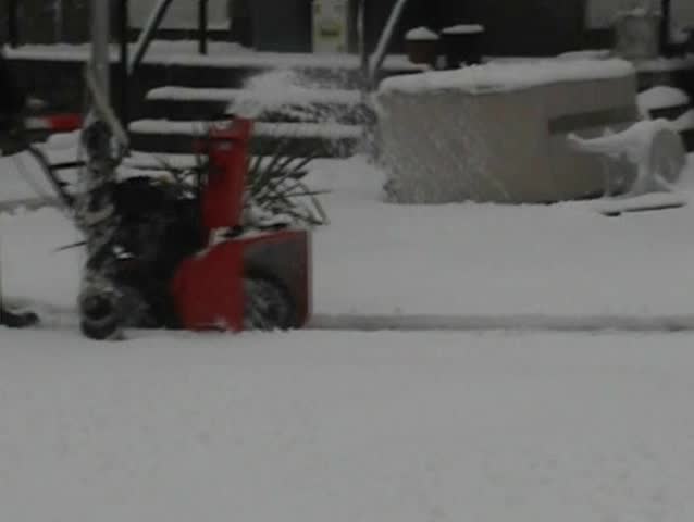 Worker Remove Snow With a Snowblower