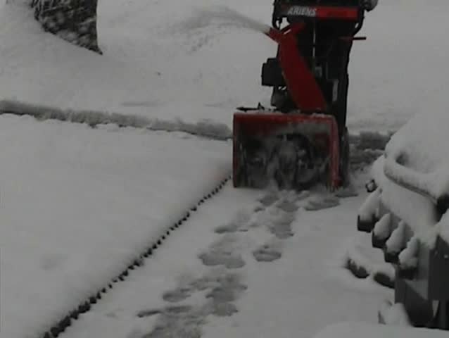 Worker Remove Snow With a Snowblower