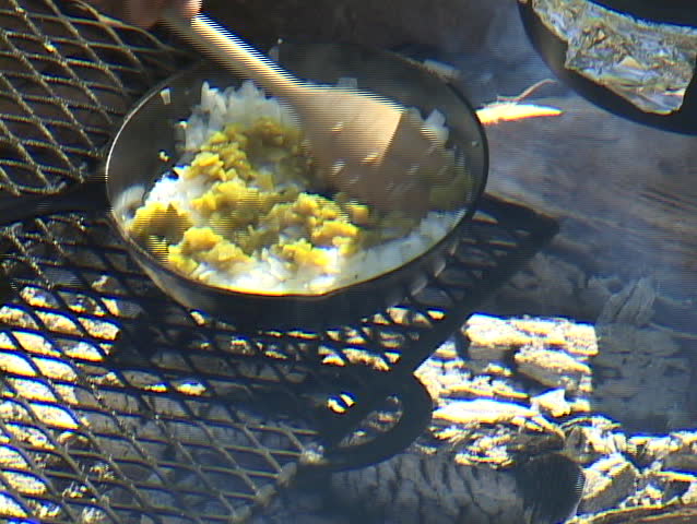 Onions and green chilies being sautÃÂ©ed in a cast-iron skillet