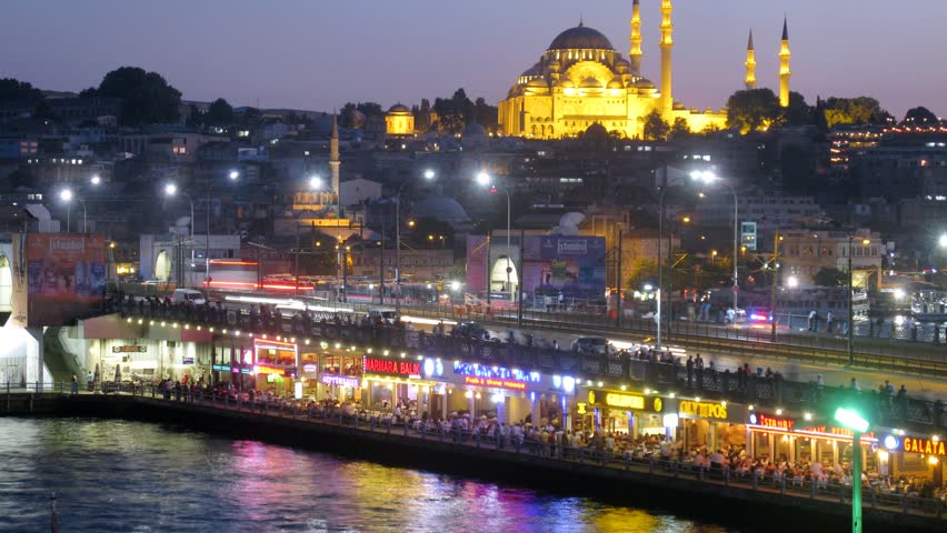 ISTANBUL - JUL 3: (Timelapse View) People have rest at restaurants under Galata Bridge, on Jul 3, 2012 in Istanbul, Turkey