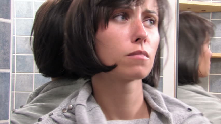 woman shows emotions in the mirror 