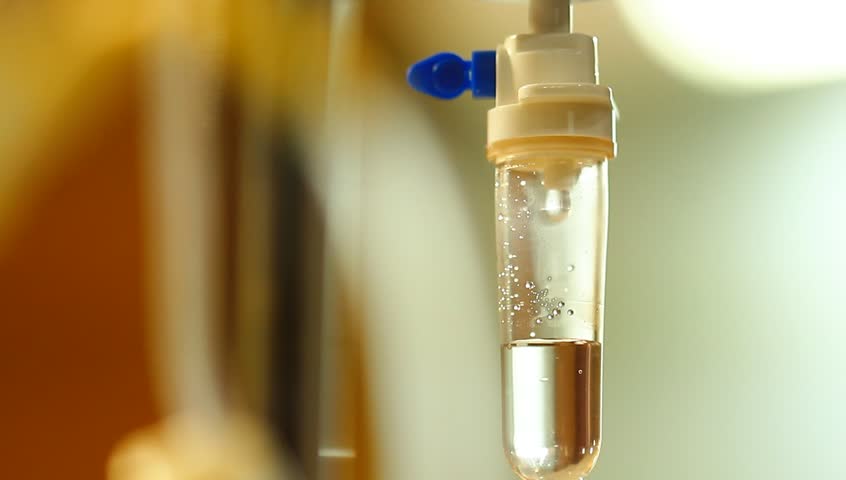 Close up dipping medical infusion iv solution and fade out