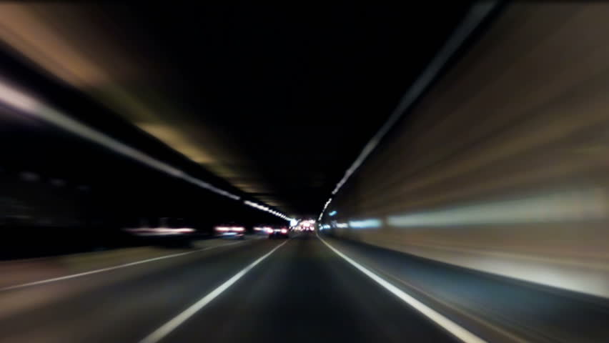 Fast car trip on the highway by night seen from the car