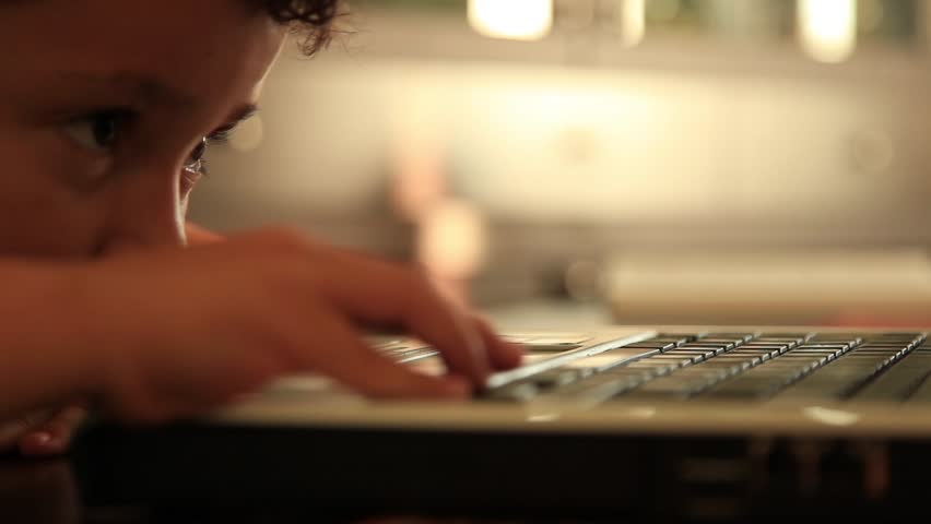 little boy playing notebook