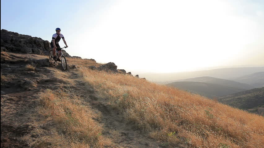A view of a biker riding a mountain bike on a sunset, Macedonia