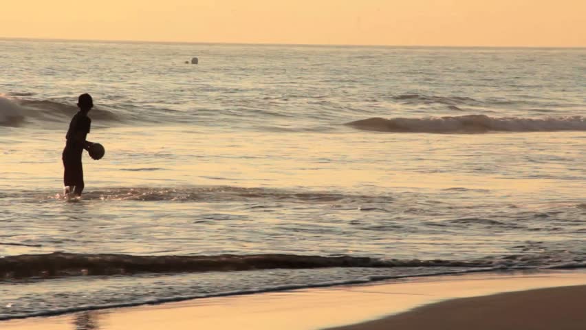 Group of latin boys playing soccer on the beach