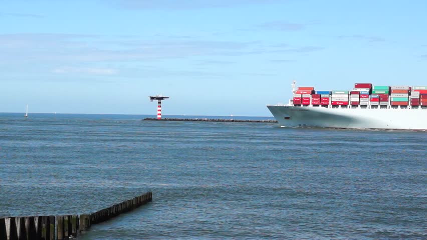 ROTTERDAM - AUGUST 2: Container Ship COSCO with full of cargo from the port of Rotterdamon on August 2, 2012. COSCO Group is the largest liner carrier in China.