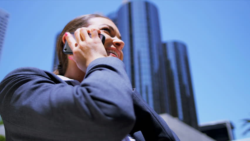 Female businesswoman excited using her smart phone Shot on Red Epic