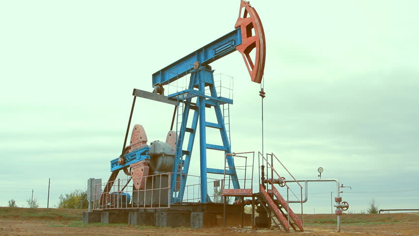 Oil and gas industry. Work of oil pump jack on a oil field.