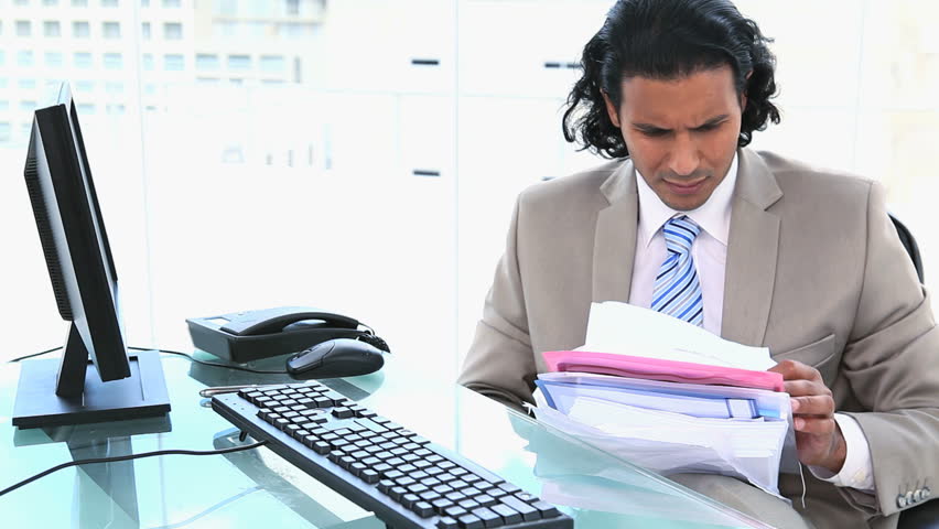 Latin businessman overworked in an office