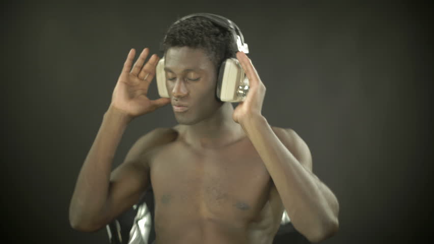 time lapse of a young african guy waving and dancing with a cool attitude while sitting 
