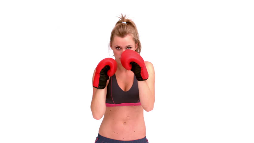 Tough woman in sports gear and boxing gloves boxing