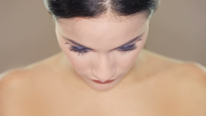 Closeup clip of a beautiful brunette woman's face with lovely brown eyes and smooth complexion