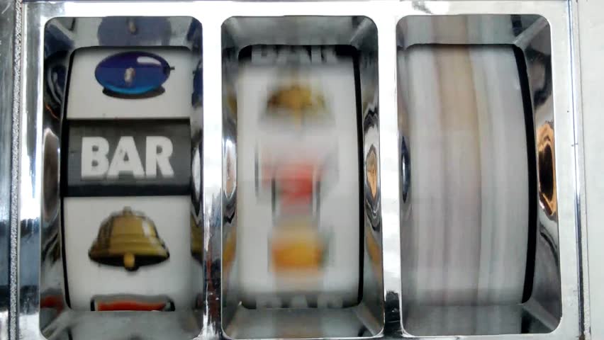Slot machine spinning to triple bar.
