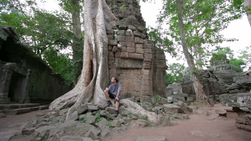 Caucasian tourist travel in Ta Prohm temple, Angkor, Cambodia
