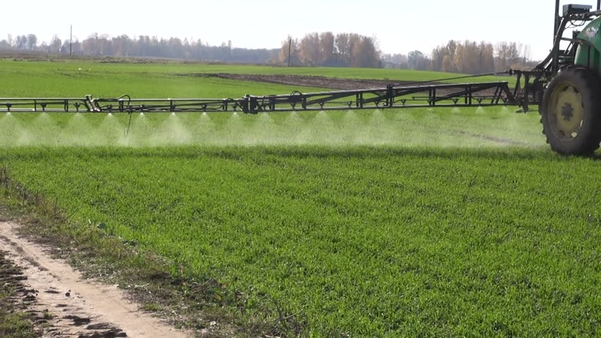 farm tractor spray autumn crop field

