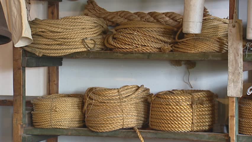 ENKHUIZEN ZUIDERZEEMUSEUM, THE NETHERLANDS - JULY 2003: traditional rope-maker's stockroom - close up coiled ropes shelves